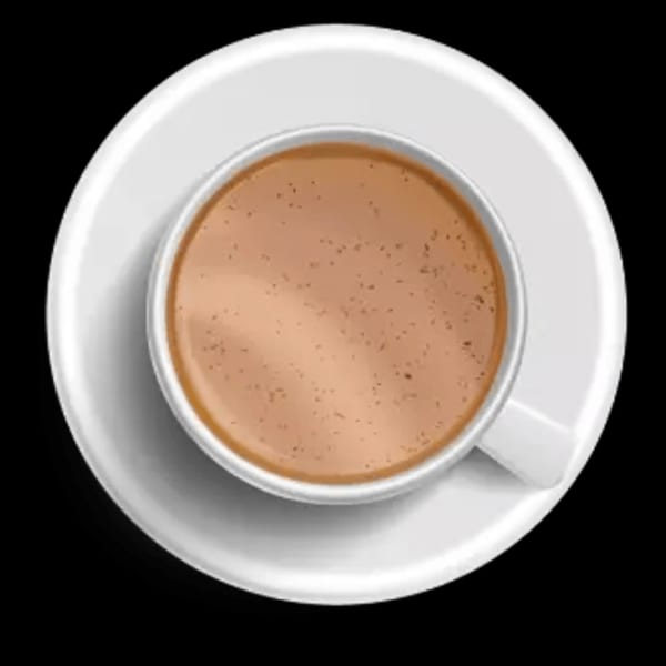 Overhead view of a white cup filled with a light brown beverage, possibly coffee or tea, on a saucer.