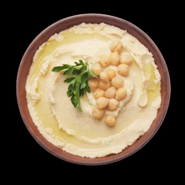 Creamy hummus in a brown bowl, garnished with chickpeas, olive oil, and fresh parsley.